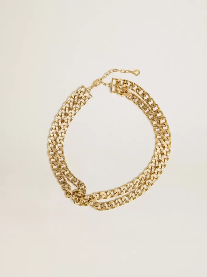 Antiek goudkleurige gevlochten ketting met stervormige sluiting.