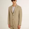 Beige herenjas met krijtstreep en enkele rij knopen, oversized pasvorm