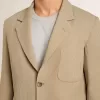Beige herenjas met krijtstreep en enkele rij knopen, oversized pasvorm