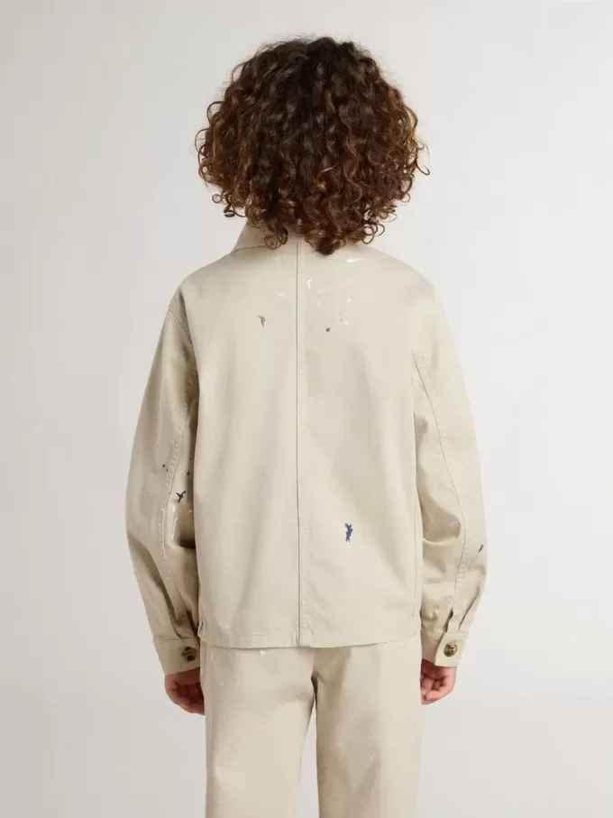 Beige kinderjasje met veelkleurige spatten