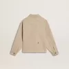Beige kinderjasje met veelkleurige spatten