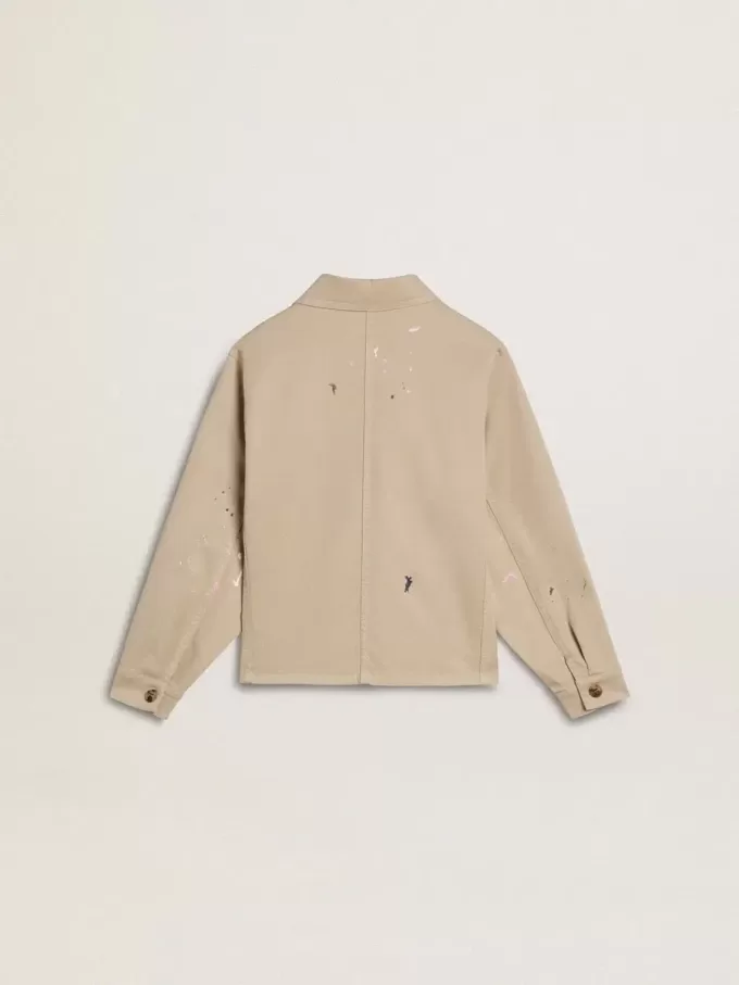 Beige kinderjasje met veelkleurige spatten