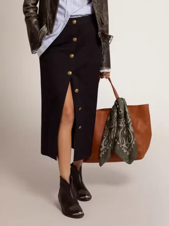 Dameskokerrok van donkerblauwe wol met gouden heraldische knopen