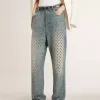Gewassen damesjeans met oogjes over het hele oppervlak