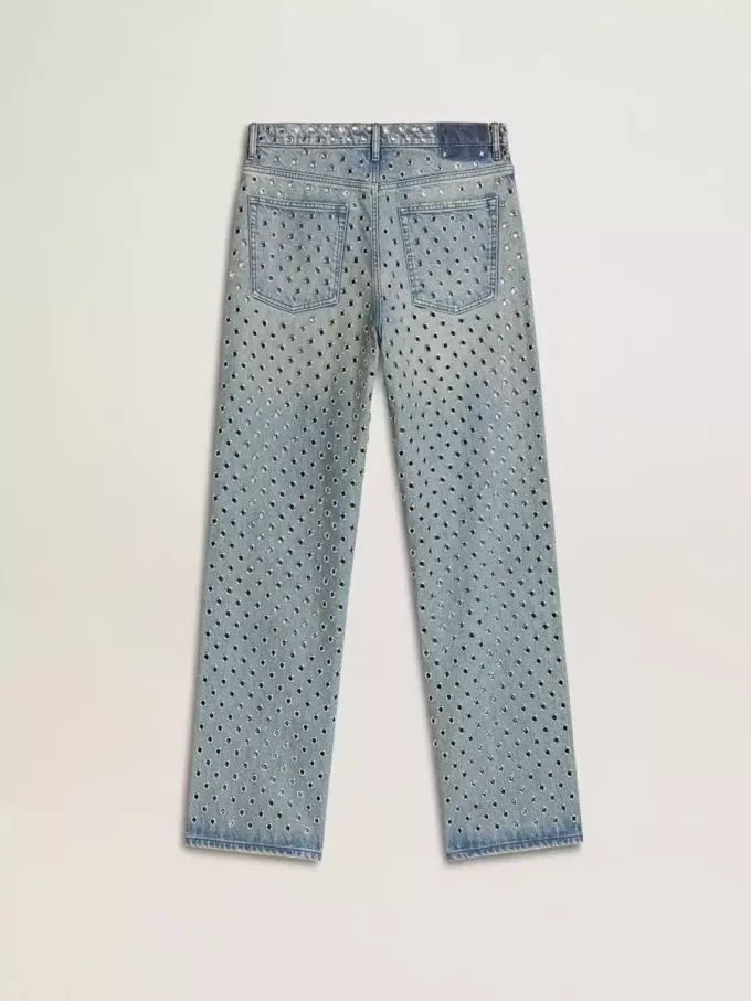 Gewassen damesjeans met oogjes over het hele oppervlak
