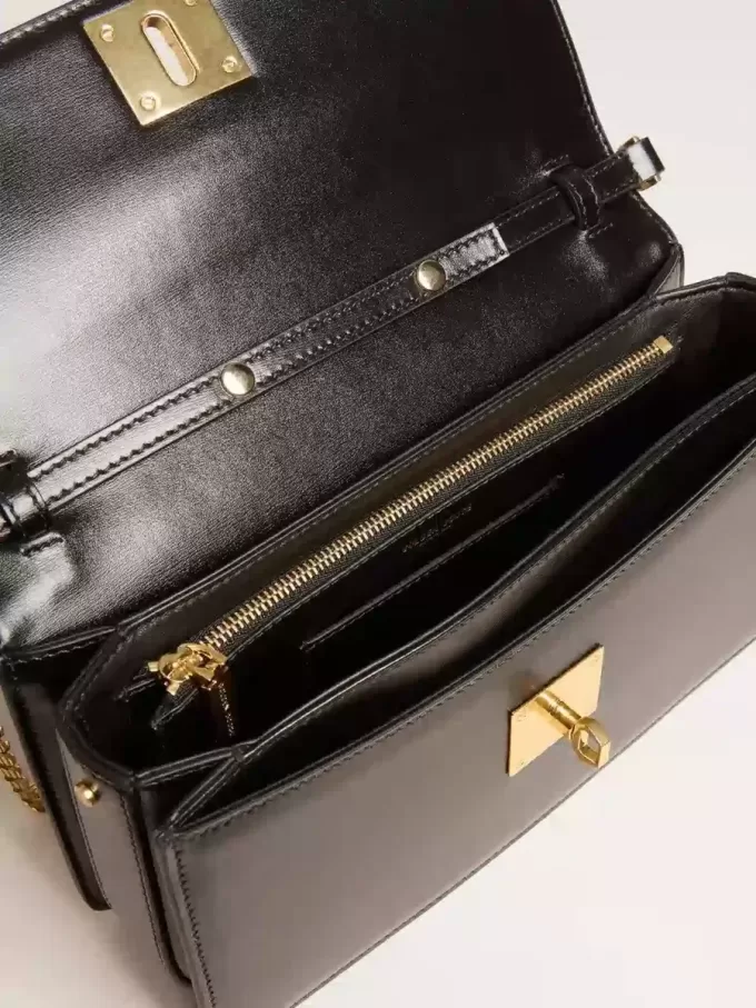 Gioia-tas in zwart leer met gouden details