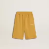 Kinderjoggingbroek in okergeel met borduursel