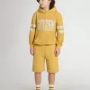 Kinderjoggingbroek in okergeel met borduursel