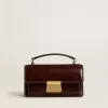 Kleine Venezia-tas van donkerbruin gelamineerd leer met gouden details