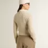 Korte trui met ronde hals van beige wol met kristallen over het hele oppervlak