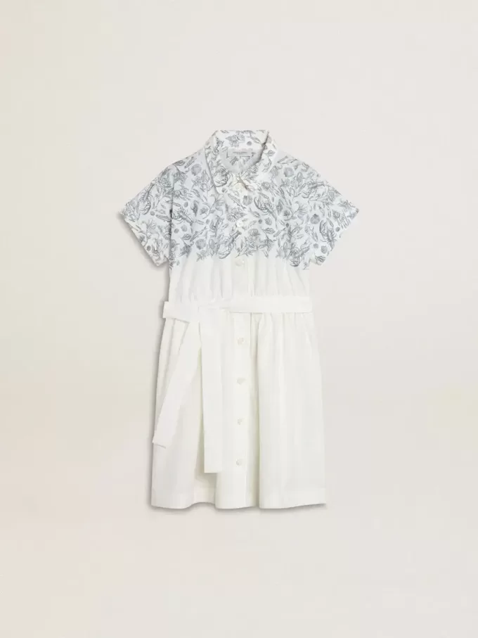 Meisjesshirtjurk van wit katoenen canvas met een blauwe nautische print en witte biezen.