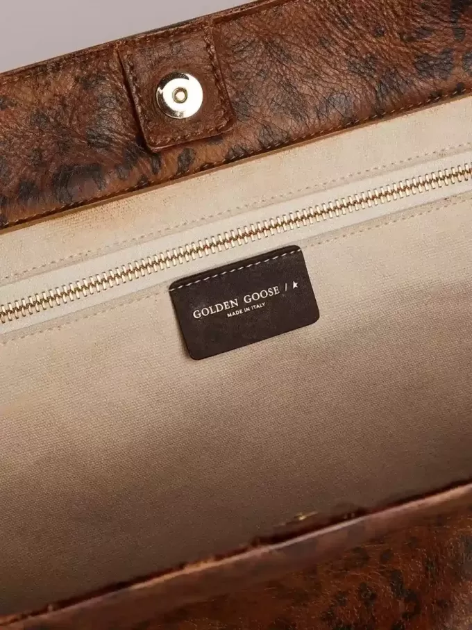 Pasadena-tas van gehamerd leer met luipaardprint en contrasterende zwarte handvatten