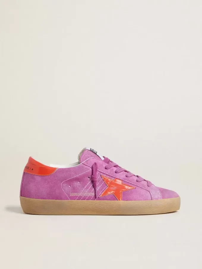 Super-Star voor dames in fuchsia suède met fluorescerende oranje gelamineerde leren ster en hielstuk.