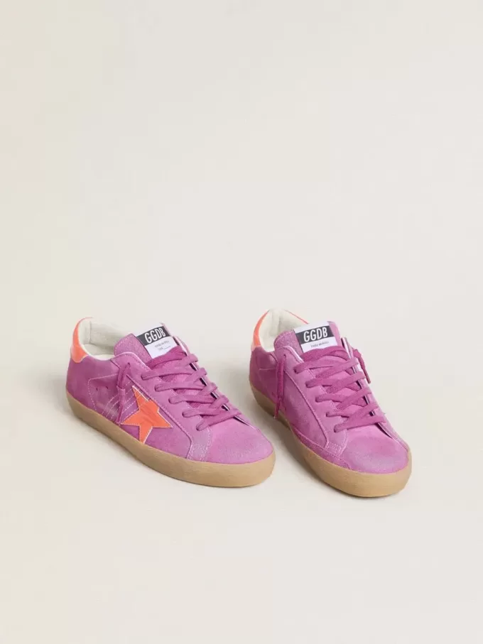 Super-Star voor dames in fuchsia suède met fluorescerende oranje gelamineerde leren ster en hielstuk.
