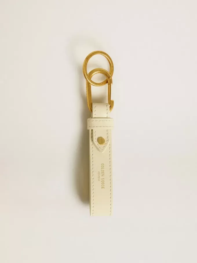 Versleten witte sleutelhanger