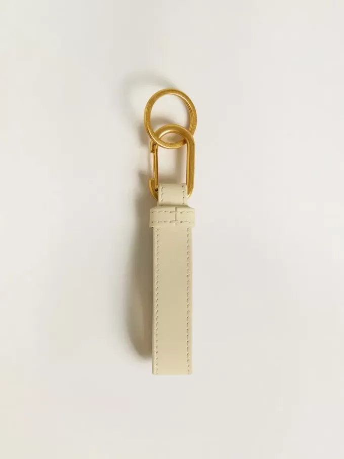 Versleten witte sleutelhanger