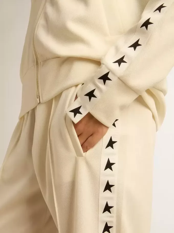 Wit damessweatshirt met ritssluiting, witte streep en zwarte sterren
