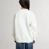 Wit sweatshirt voor meisjes met veelkleurige gouden letters op de voorkant.