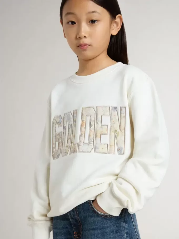 Wit sweatshirt voor meisjes met veelkleurige gouden letters op de voorkant.