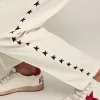 Witte joggingbroek voor heren met zwarte sterren aan de zijkanten
