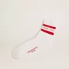 Witte sokken met distressed details en rode strepen