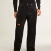 Zwarte herenjeans met een losse pasvorm en een all-over kristallen met kleurverloop.