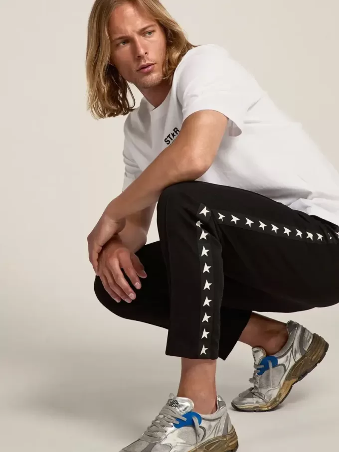 Zwarte joggingbroek voor heren met witte sterren aan de zijkanten