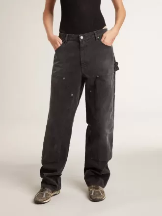 Zwarte katoenen damesjeans met slijtage-effect en patches aan de voorkant