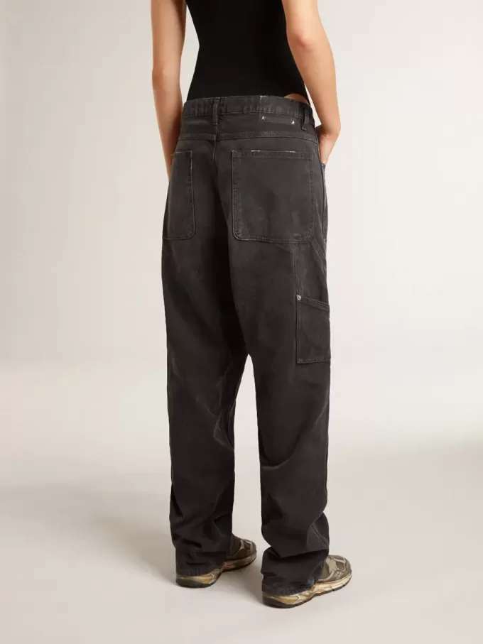 Zwarte katoenen damesjeans met slijtage-effect en patches aan de voorkant