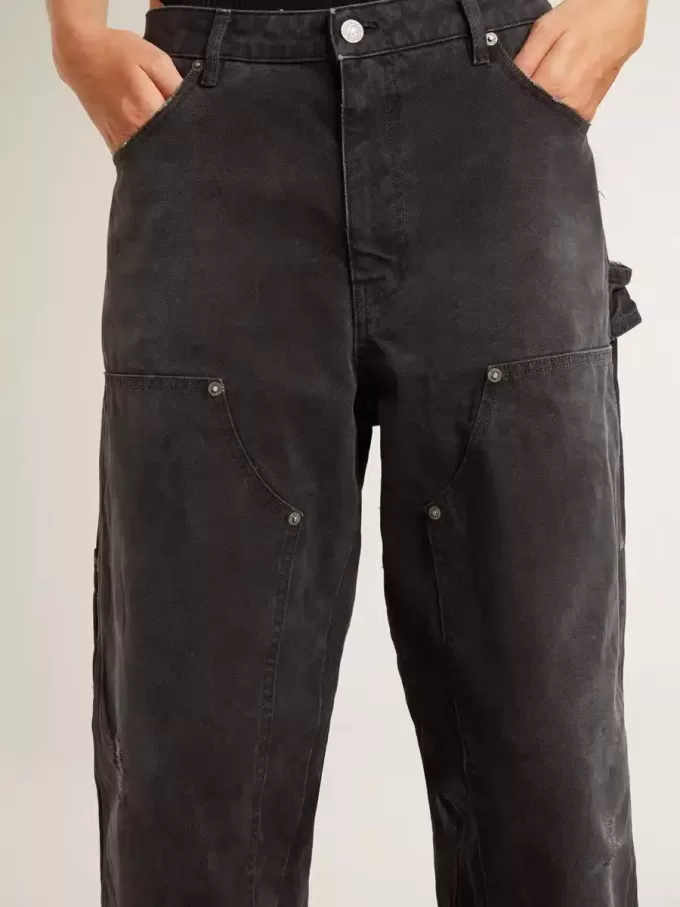 Zwarte katoenen damesjeans met slijtage-effect en patches aan de voorkant