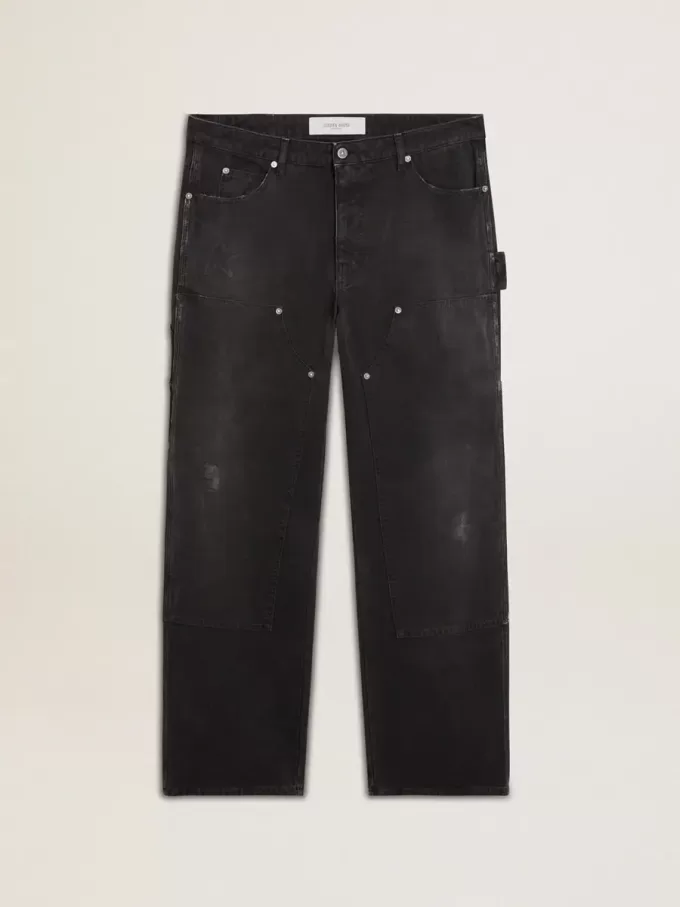Zwarte katoenen herenjeans met versleten effect en patches aan de voorkant