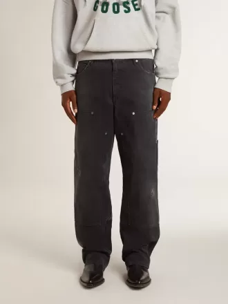 Zwarte katoenen herenjeans met versleten effect en patches aan de voorkant