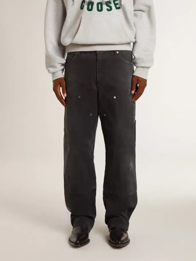 Zwarte katoenen herenjeans met versleten effect en patches aan de voorkant