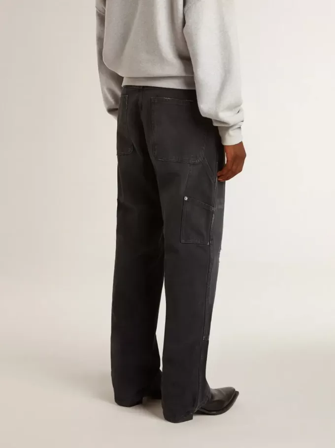 Zwarte katoenen herenjeans met versleten effect en patches aan de voorkant