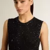 Zwarte mesh-top met pailletten en contrasterende details